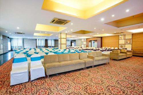 a banquet hall with chairs and tables in a room at The Sky Comfort, Ahmedabad in Ahmedabad