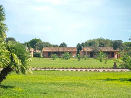 a house in the middle of a green field at ISA-Village with swimming-pool and private equipped beach in Montalto Marina in Torre di Montalto