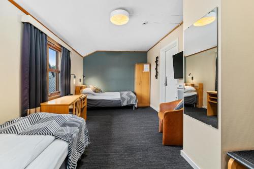 a hotel room with two beds and a tv at Lakselv Hotel in Lakselv