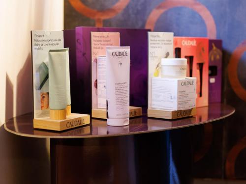 a shelf with four bottles of cream on it at Dwór Prezydencki Boutique Hotel & SPA in Tarnów