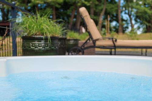 a swimming pool with a chair and a table and chairs at Dwór Prezydencki Boutique Hotel & SPA in Tarnów
