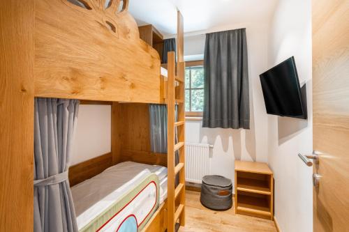 a bedroom with bunk beds in a tiny house at Familotel Amiamo in Zell am See