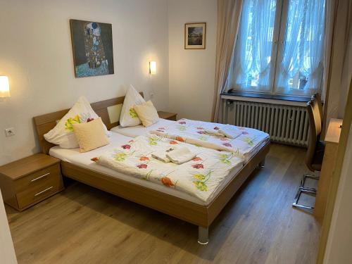 a bed in a room with a window and a bed sidx sidx sidx at Hotel Haus Schwan Köln in Cologne