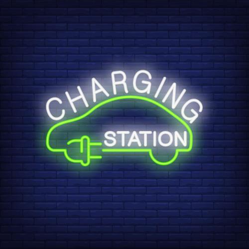 a neon sign of a car charging station on a brick wall at La Grange in Rochehaut