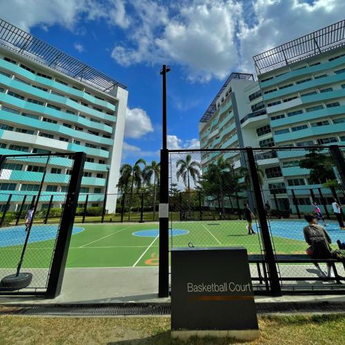 a tennis court in front of two tall buildings at 1 Bedroom Penthouse 3BEDS Sunset & City lights with big balcony FREE ACCESS to all amenities in Manila