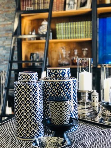 a group of vases sitting on top of a table at Villa Maolo in Roquebrune-sur-Argens