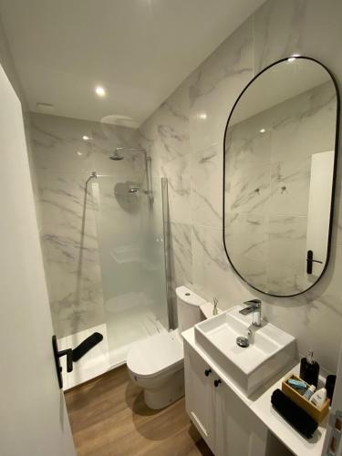 une salle de bain avec un lavabo, des toilettes et un miroir dans l'établissement La parenthèse T2 tout neuf moderne et chaleureux, à Chalon-sur-Saône