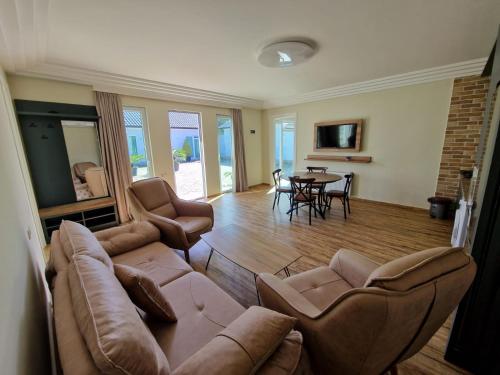 a living room with a couch and chairs and a table at White villas in Batumi in Batumi