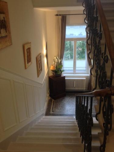a staircase in a house with a window at La Résidence de l'Orangerie in Strasbourg
