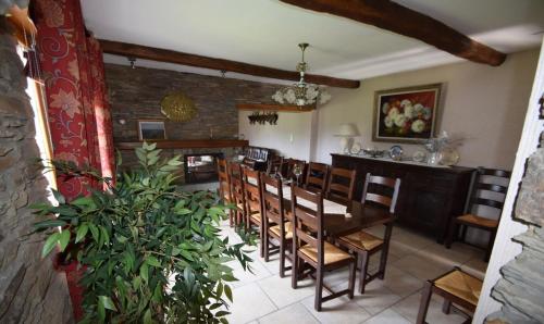 a dining room with a wooden table and chairs at La Petite Ferme in Rochehaut