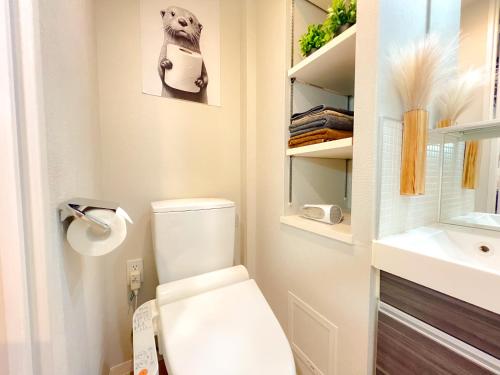 a bathroom with a white toilet and a sink at Shinjuku Downtown BZT Free WiFi in Tokyo