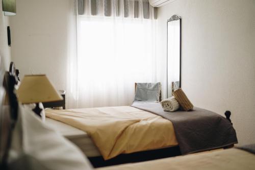 a bedroom with a bed with a large window at Host Wise - Terrace & Ocean View Flat in Armação de Pêra