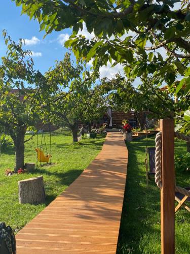 a wooden path in a park with trees and grass at Czereśniowe Wzgórze Sandomierz jakuzzi in Sandomierz