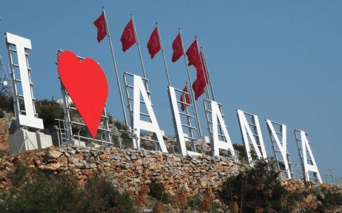a row of red flags on top of a building at My Boutique Hotel in Alanya