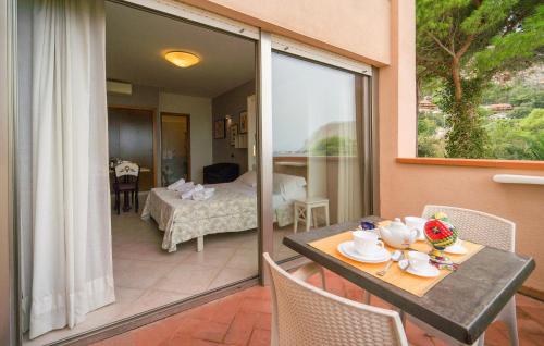 a balcony with a table and chairs and a bedroom at Bilo 4 in Lido di Mondello