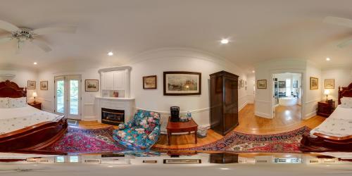 a large living room with two beds and a fireplace at Benn Conger Inn in Groton