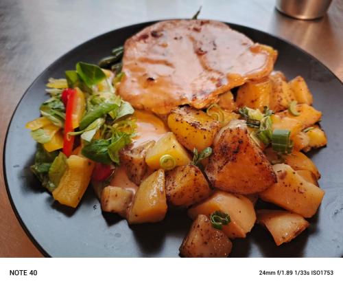 a plate of food with potatoes and meat and vegetables at Penzion Kristýna in Hrušovany nad Jevišovkou