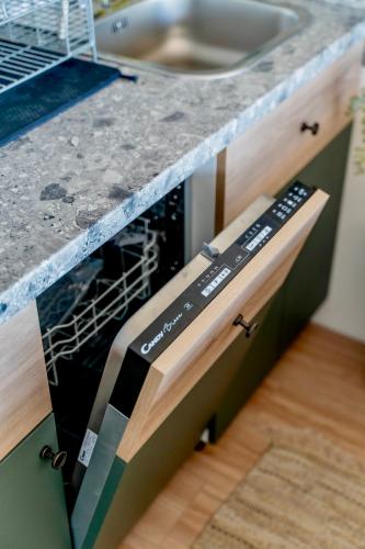 a dishwasher in a kitchen with a counter top at Rent a NEST in Arandjelovac