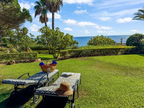 a picnic table with two hats on top of it at Boutique Hotel Vivenda Miranda in Lagos