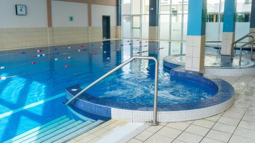 a large swimming pool with a large tub of water at Lady Gregory Hotel, Leisure Club & Beauty Rooms in Gort