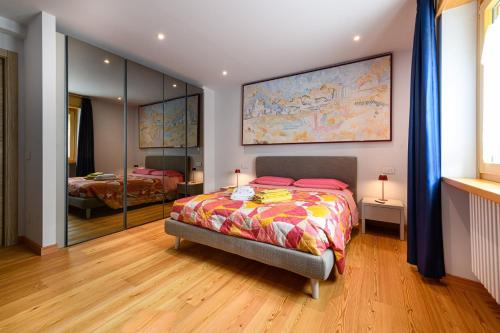 a bedroom with a bed and a large mirror at Le Caronelle in Villa di Tirano