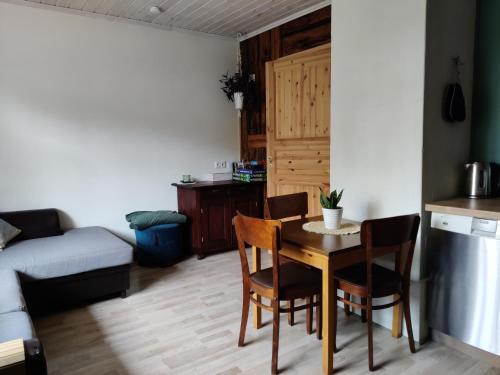 a kitchen and living room with a table and chairs at Suure terrassiga korter raudteejaama lähedal in Viljandi