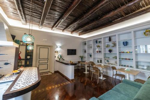 a living room with a table and chairs and a dining room at B & B Boutique Epoca in Salerno