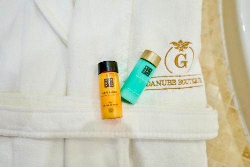 a bottle of tanner brothers and a bottle of sunscreen at G Danube Boutique Hotel in Brăila