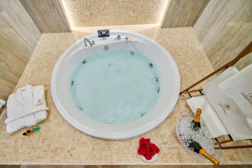 a bath tub with a sink in a bathroom at G Danube Boutique Hotel in Brăila