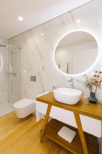 a bathroom with a sink and a mirror at Casa Vieira Lobo in Arouca