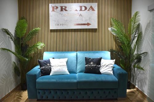 a blue couch with black and white pillows on it at B&B Romeo2 in Bari