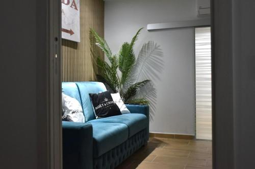 a blue couch in a living room with a plant at B&B Romeo2 in Bari