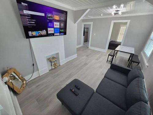 a living room with a couch and a flat screen tv at Casa moderna, a newly renovated Modern apartment in West Palm Beach