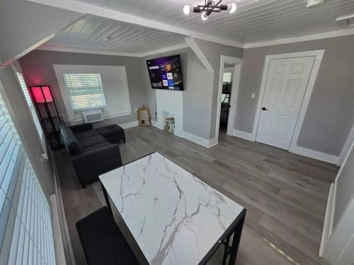 a living room with a marble table and a couch at Casa moderna, a newly renovated Modern apartment in West Palm Beach
