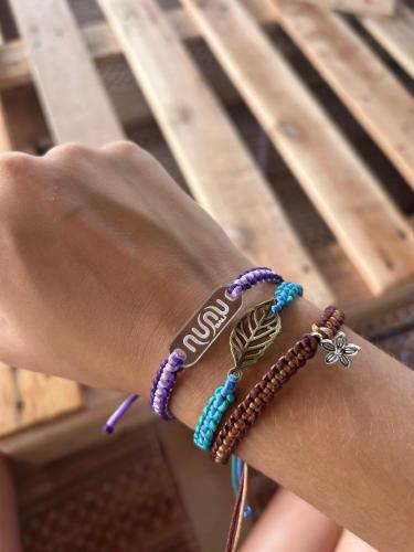 a persons hand with bracelets on a wrist at Nunu Bali Eco Friendly Retreat in Canggu