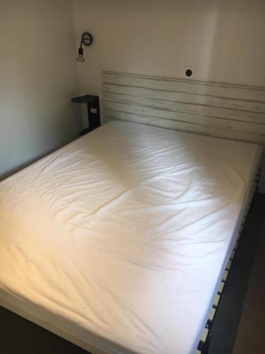 a large white bed in a room at Camping Cala Llevado in Tossa de Mar
