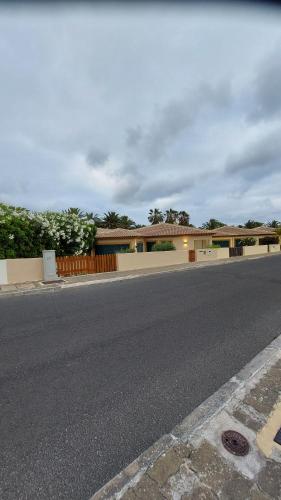an empty street in front of a house at Pé n' Areia Beach House Porto Santo in Porto Santo