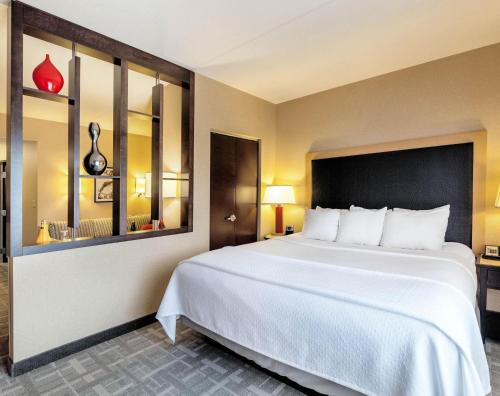 a large white bed in a hotel room at Cambria Hotel Pittsburgh - Downtown in Pittsburgh