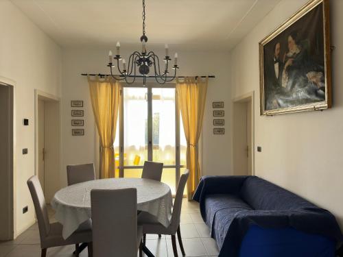 a living room with a table and a blue couch at Venetian Mood: Secret Garden in Venice