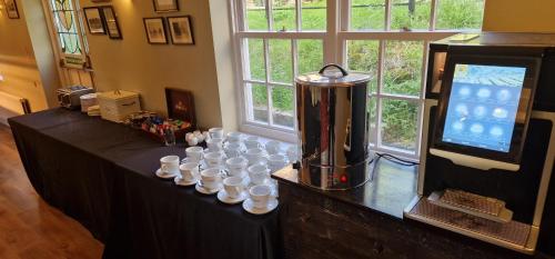 a table with a blender and a bunch of cups at White Horse Farm Inn in Pickering