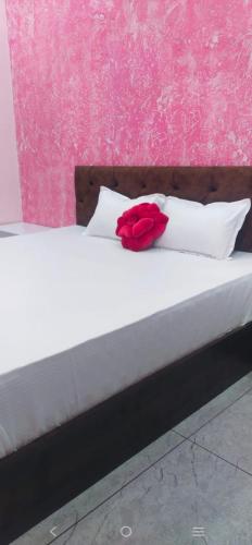 a red rose sitting on top of a bed at Anant home stay in Ujjain