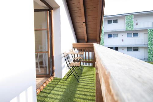 a patio with a table and chair on a balcony at Apartmenthaus ROSE in Prutz