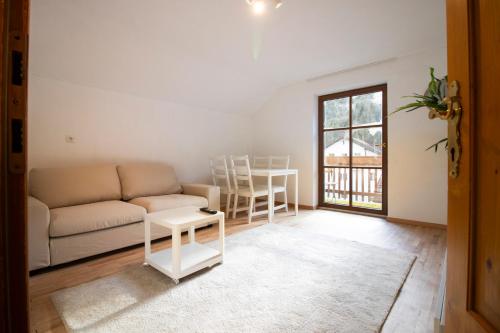 a living room with a couch and a table at Apartmenthaus ROSE in Prutz
