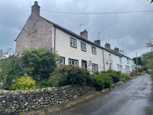 a row of white houses on the side of a street at The Nook at Ullswater in Penrith