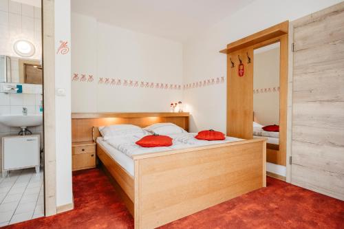 a bedroom with a bed with a mirror and a sink at Landhotel Neuhof in Zenting