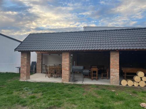 a house with a patio with tables and chairs at Apartmány Diana in Lužice
