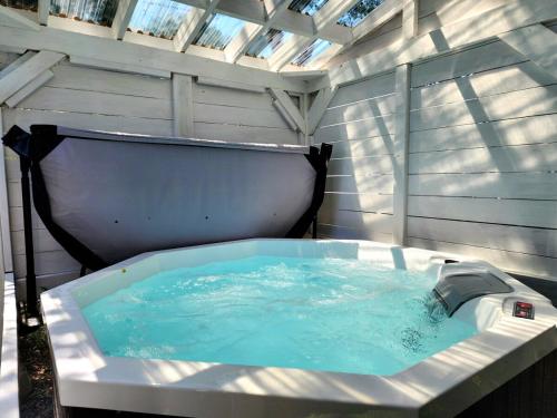 a bath tub in aitating at Luxury Retreat with Hot Tub - EV Chrger & Parking in Quebec City