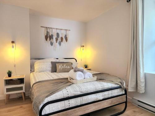 a bedroom with a bed with two stuffed animals on it at The Coziest - Hot Tub - EV Chrger & Free Parking in Quebec City
