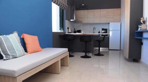 a living room with a couch and a kitchen at Phaedra's Studios in Kolymbari in Chania Town