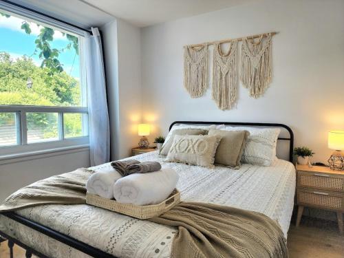a bedroom with a bed with a large window at The Coziest - Hot Tub - EV Chrger & Free Parking in Quebec City